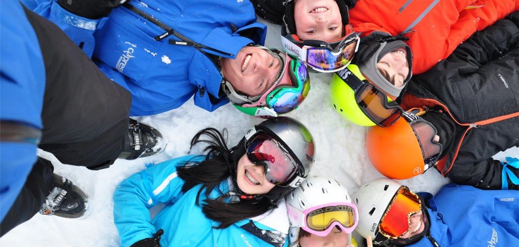 Ski instructor and children taking a class